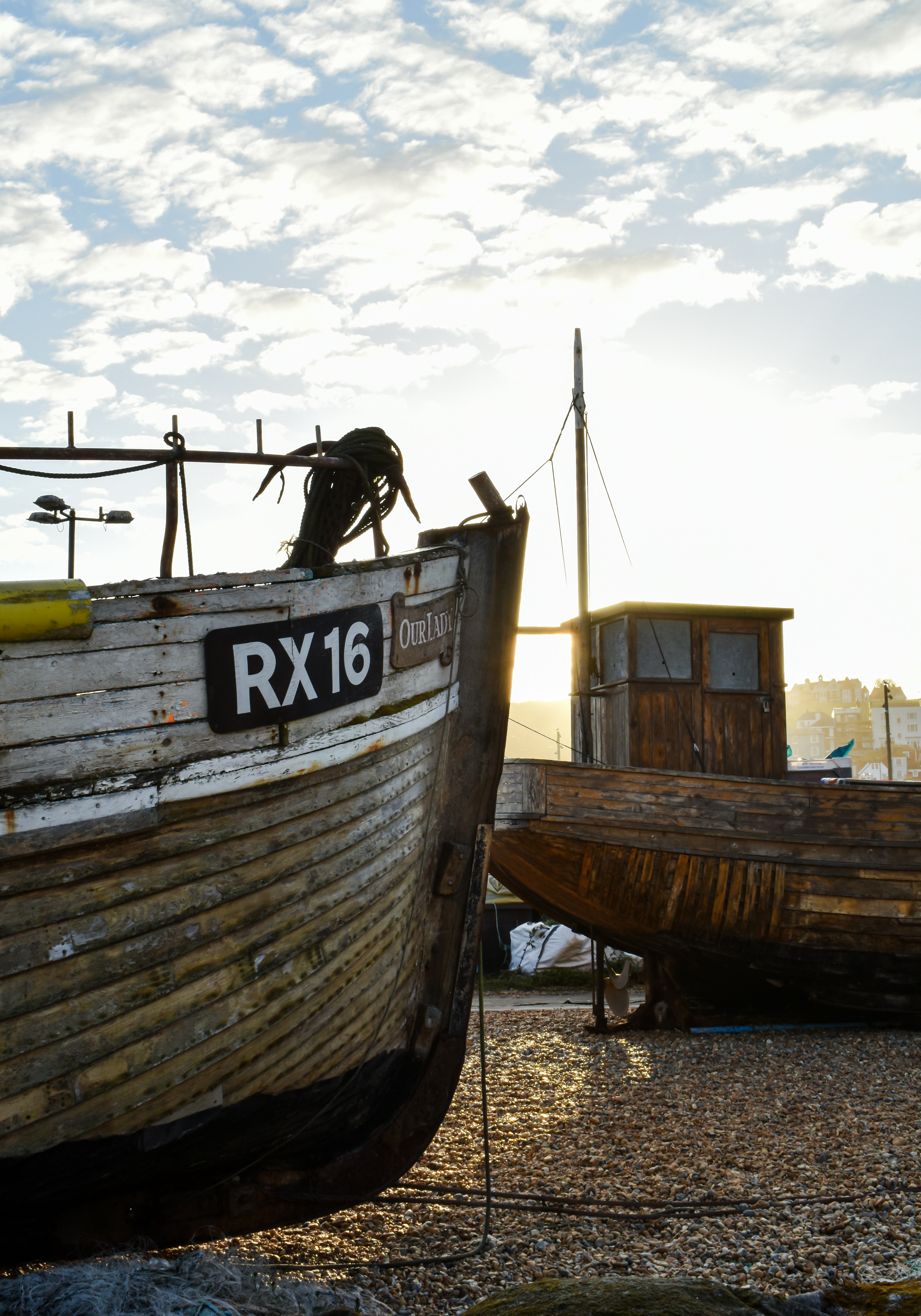 brown wooden boat on beach shore during daytime